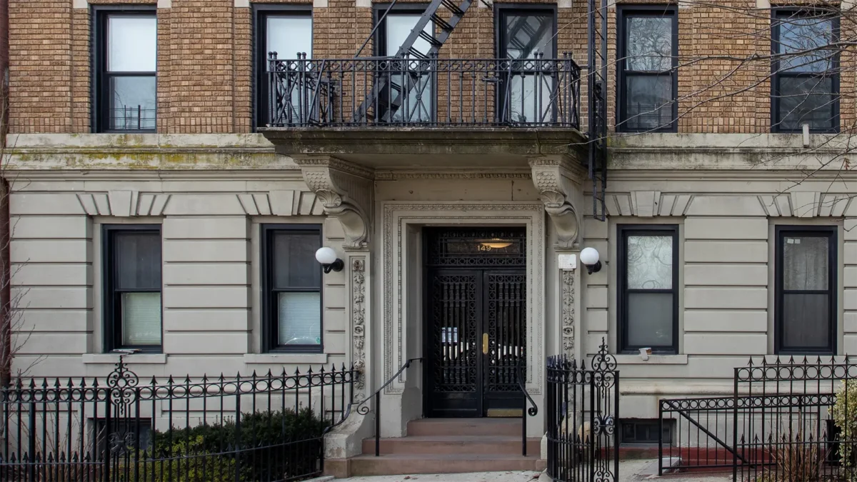 Art Deco co-op building exterior with short iron gate in front