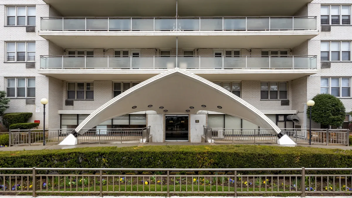 White A-frame art deco-inspired co-op exterior