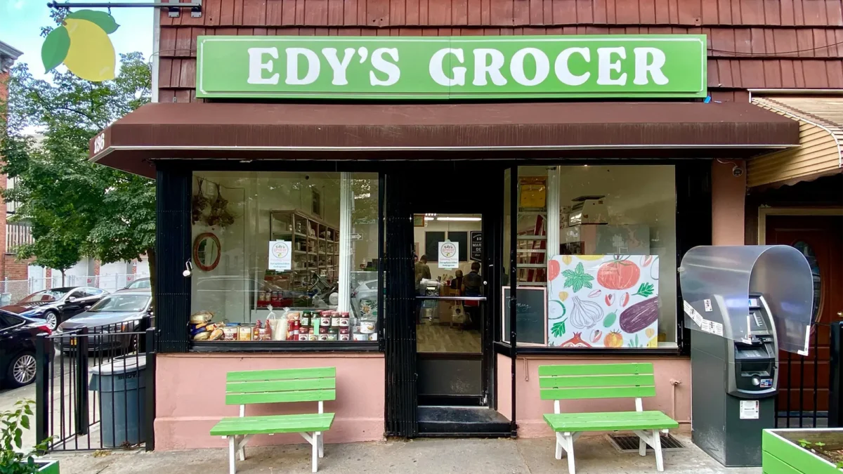 Sign reading "Edy's Grocer" above building exterior storefront