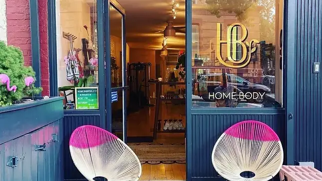 Gym storefront exterior with two round chairs in front