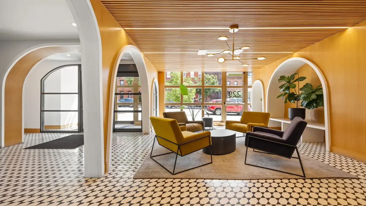Renovated modern building lobby with tile floor and arched doorways