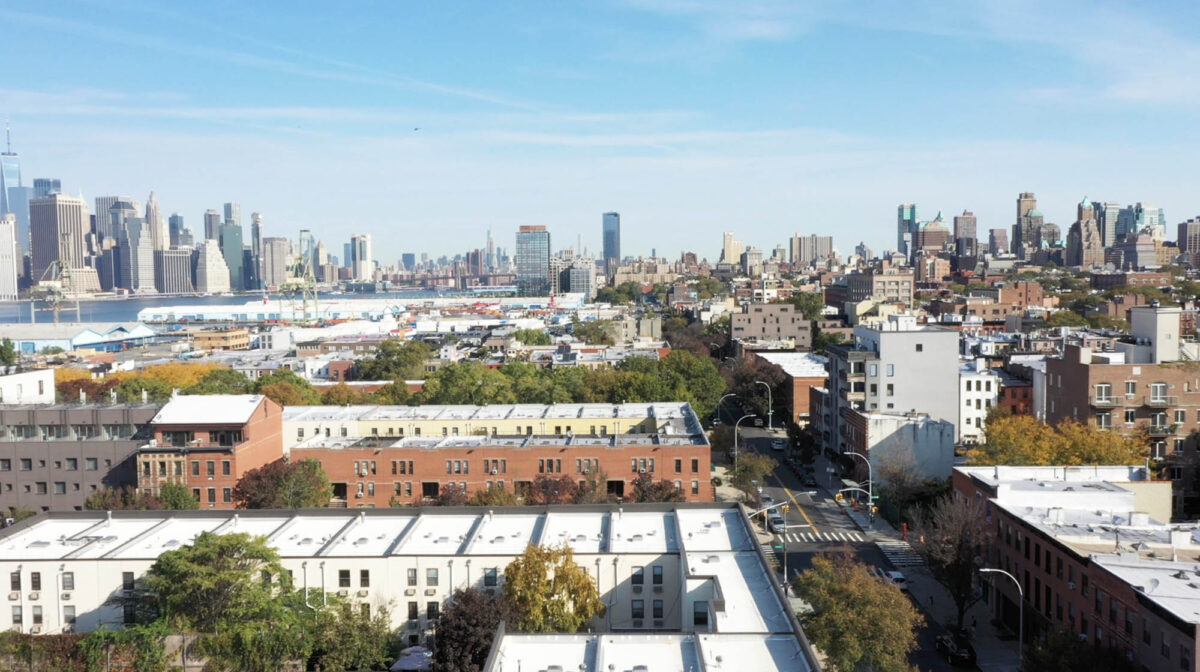 Aerial view of Brooklyn rooftops with skyline in background
